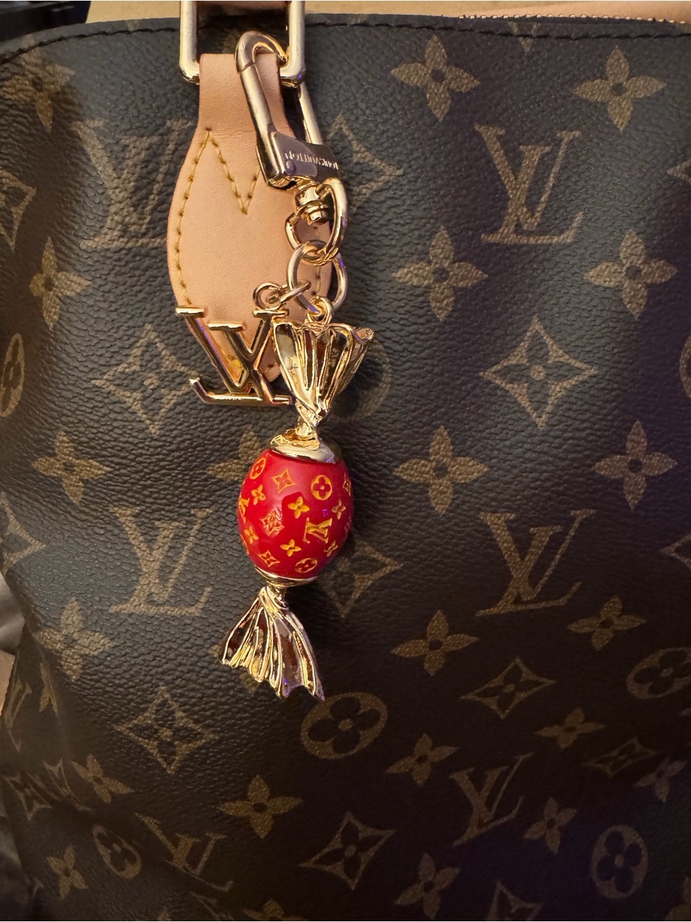 Louis Vuitton Monogram Tote with Gold-Tone Charm and Red Logo Accent
